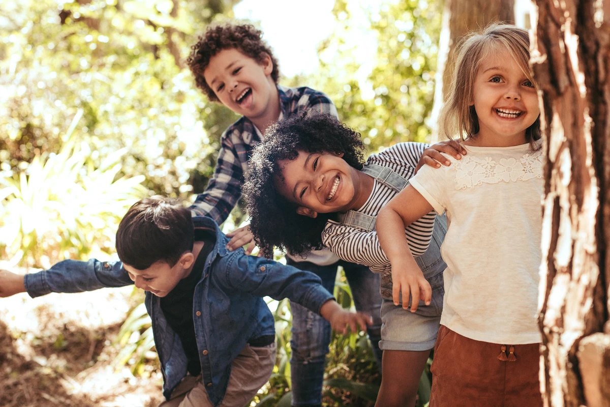 Glada barn leker i en skog