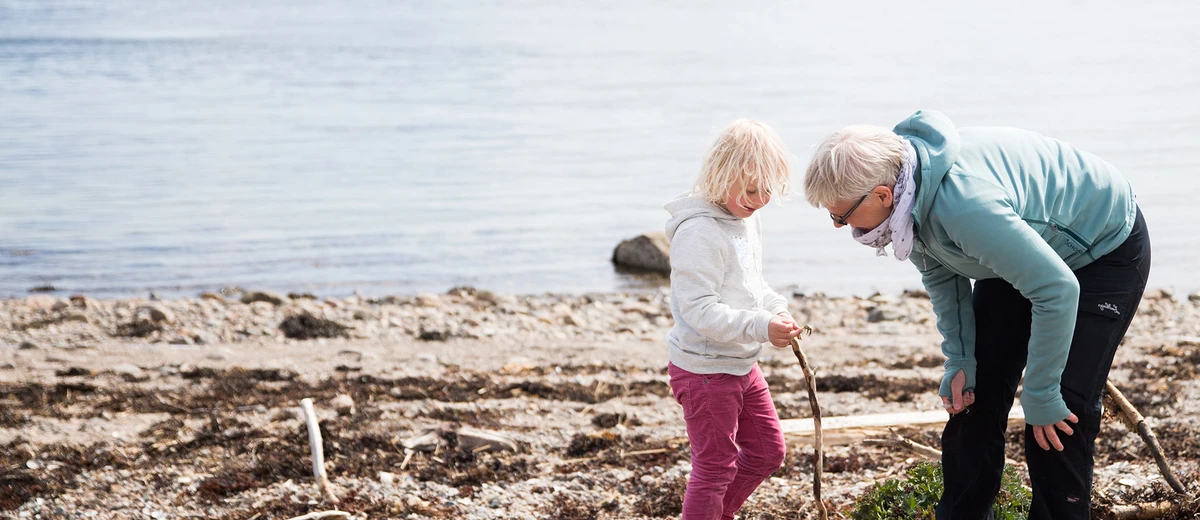 Skräpplockare på strand i Bohuslän.