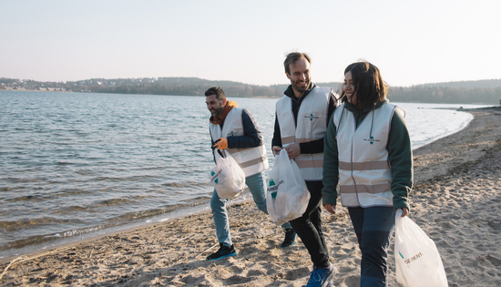 personer plockar skräp på strand